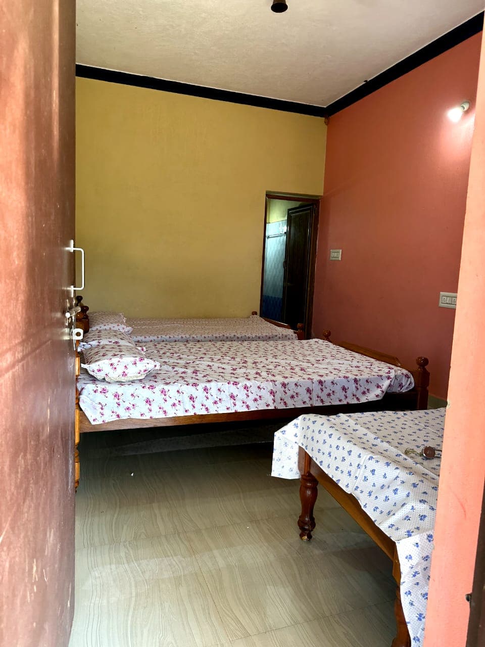 Clean room with two beds and fresh linen at Kudremukh trek base homestay in Mullodi