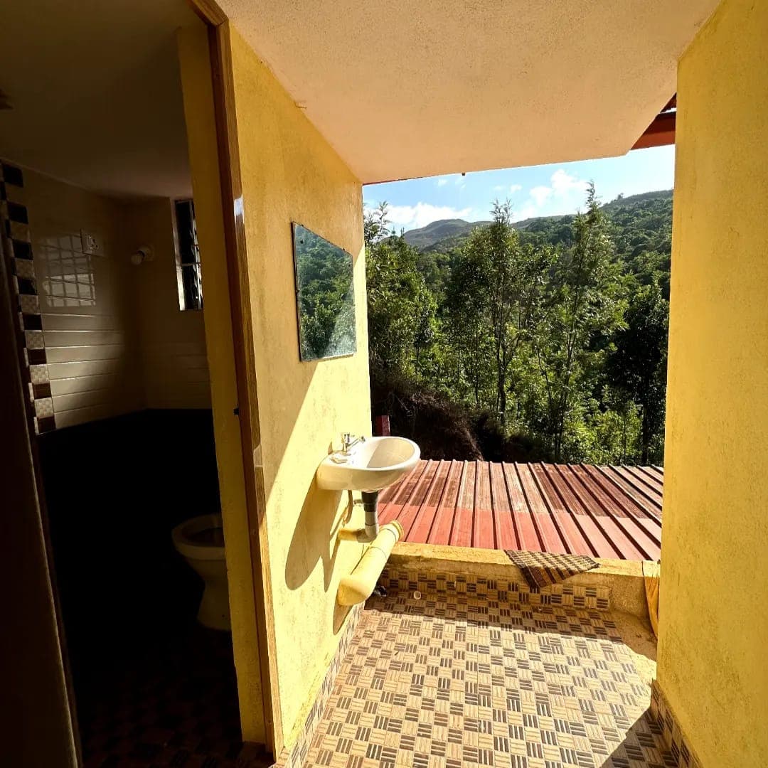 Washroom area opening onto a valley view at Mullodi homestay in Kudremukh